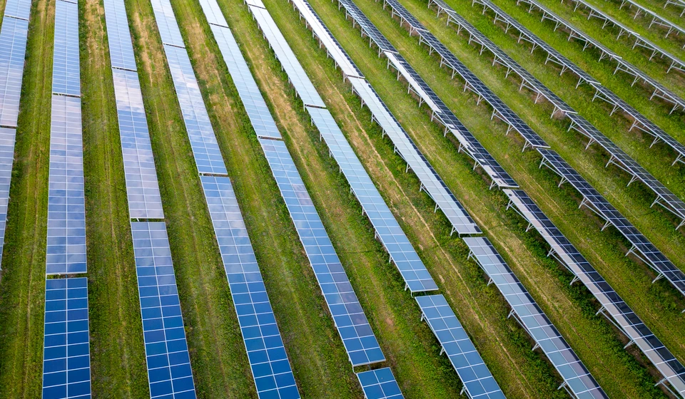 big-solar-power-station-on-a-green-meadow-aerial