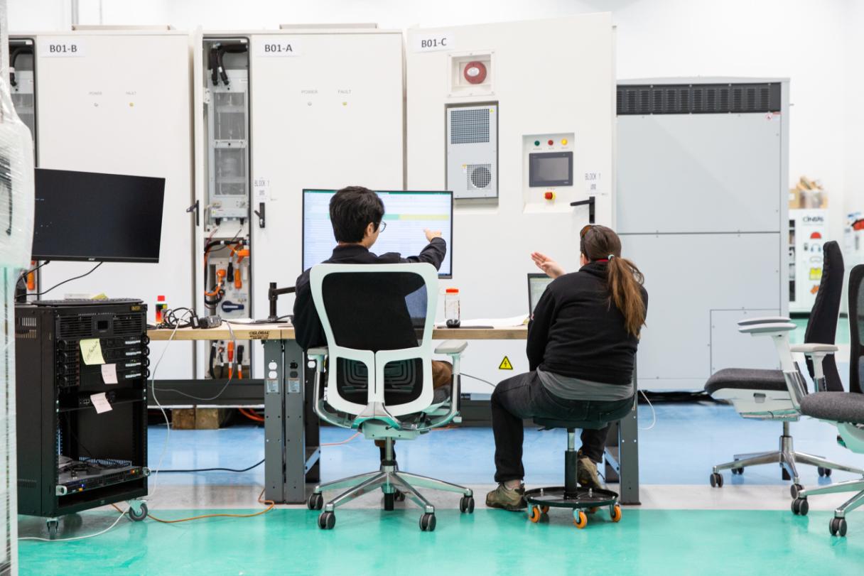 Engineers working on computers in lab